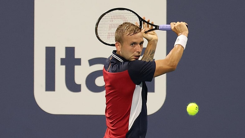 Mar 26, 2021; Miami, Florida, USA; Daniel Evans of Great Britain hits a backhand against Frances Tiafoe of the United States (not pictured) in the second round in the Miami Open at Hard Rock Stadium. Mandatory Credit: Geoff Burke-USA TODAY Sports