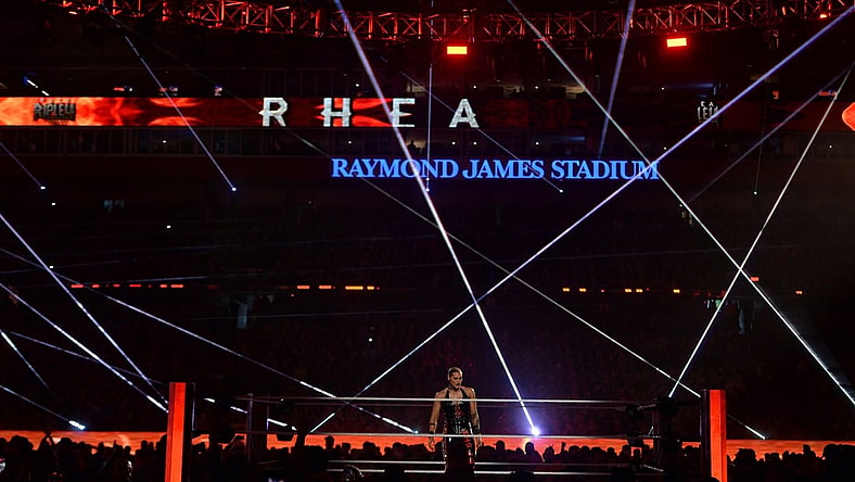 Apr 11, 2021; Tampa, Florida, USA; Asuka (green/yellow attire) and Rhea Ripley (black attire) during the Raw Women's Championship match at WrestleMania 37 at Raymond James Stadium. Mandatory Credit: Joe Camporeale-USA TODAY Sports