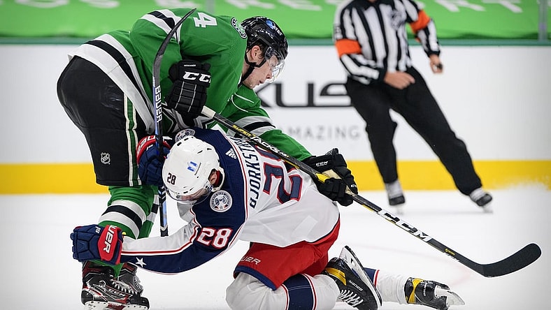 Apr 15, 2021; Dallas, Texas, USA; Columbus Blue Jackets right wing Oliver Bjorkstrand (28) collides with Dallas Stars defenseman Miro Heiskanen (4) during the first period at the American Airlines Center. Mandatory Credit: Jerome Miron-USA TODAY Sports