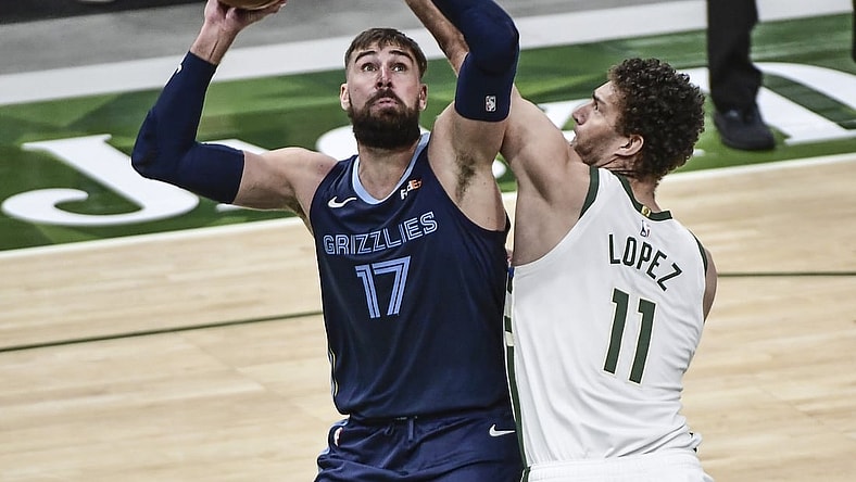 Apr 17, 2021; Milwaukee, Wisconsin, USA; Memphis Grizzlies center Jonas Valanciunas (17) takes a shot against Milwaukee Bucks center Brook Lopez (11) in the third quarter at Fiserv Forum. Mandatory Credit: Benny Sieu-USA TODAY Sports