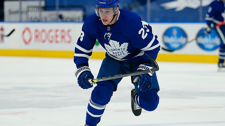 Apr 13, 2021; Toronto, Ontario, CAN; Toronto Maple Leafs defenseman Travis Dermott (23) skates against the Calgary Flames during the second period at Scotiabank Arena. Mandatory Credit: John E. Sokolowski-USA TODAY Sports