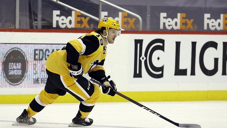 Apr 22, 2021; Pittsburgh, Pennsylvania, USA; Pittsburgh Penguins center Jared McCann (19) skates with the puck against the New Jersey Devils during the third period at PPG Paints Arena. Pittsburgh won 5-1. Mandatory Credit: Charles LeClaire-USA TODAY Sports