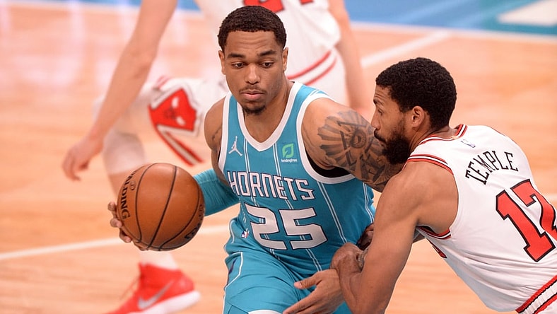 May 6, 2021; Charlotte, North Carolina, USA;  Charlotte Hornets forward center PJ Washington (25) drives past Chicago Bulls guard forward Garrett Temple (17) during the first half at the Spectrum Center. Mandatory Credit: Sam Sharpe-USA TODAY Sports.
