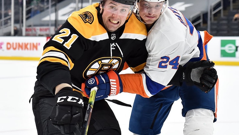 May 10, 2021; Boston, Massachusetts, USA;  Boston Bruins left wing Nick Ritchie (21) and New York Islanders defenseman Nick Leddy (2) battle for position during the second period at TD Garden. Mandatory Credit: Bob DeChiara-USA TODAY Sports