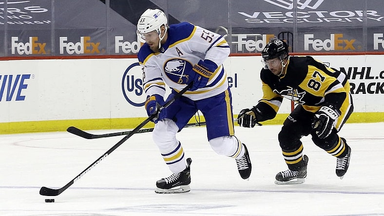 May 8, 2021; Pittsburgh, Pennsylvania, USA;  Buffalo Sabres defenseman Rasmus Ristolainen (55) skates up ice with the puck as Pittsburgh Penguins center Sidney Crosby (87) chases during the first period at PPG Paints Arena. Mandatory Credit: Charles LeClaire-USA TODAY Sports