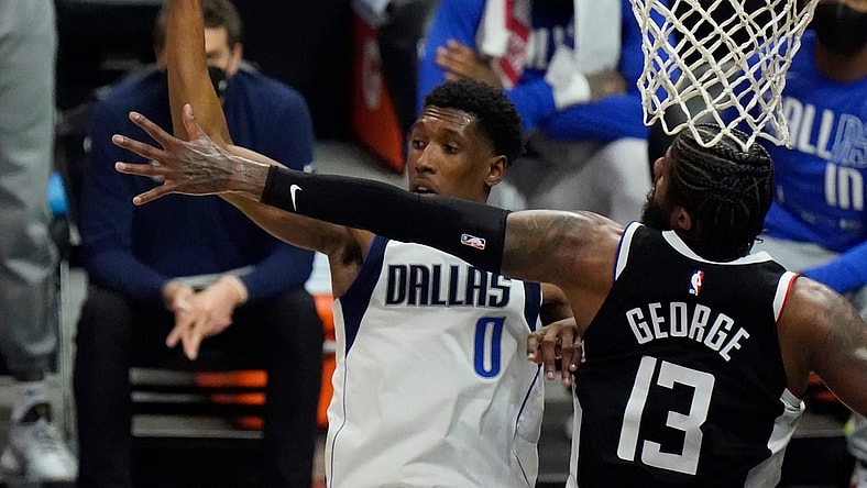 May 22, 2021; Los Angeles, California, USA; Dallas Mavericks guard Josh Richardson (0) hangs in the air as he passes off top a teammate as LA Clippers guard Paul George (13) defends in the second quarter of game one in the first round of the 2021 NBA Playoffs at Staples Center. Mandatory Credit: Robert Hanashiro-USA TODAY Sports