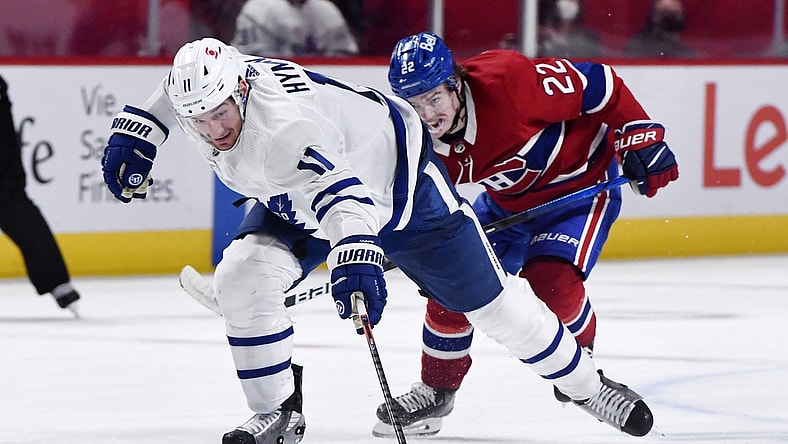 May 25, 2021; Montreal, Quebec, CAN; Toronto Maple Leafs forward Zach Hyman (11) plays the puck and Montreal Canadiens forward Cole Caufield (22) gives chase during the third period in game four of the first round of the 2021 Stanley Cup Playoffs at Bell Centre. Mandatory Credit: Eric Bolte-USA TODAY Sports