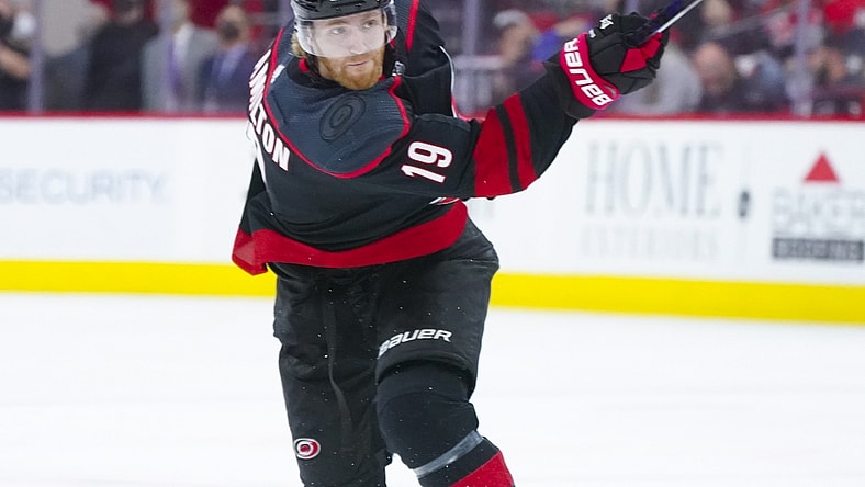 May 30, 2021; Raleigh, North Carolina, USA; Carolina Hurricanes defenseman Dougie Hamilton (19) takes a shot against the Tampa Bay Lightning in game one of the second round of the 2021 Stanley Cup Playoffs at PNC Arena. Mandatory Credit: James Guillory-USA TODAY Sports