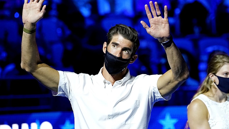 Jun 18, 2021; Omaha, Nebraska, USA; Michael Phelps waves to the crowd during the Medal Ceremony during the U.S. Olympic Team Trials Swimming competition at CHI Health Center Omaha. Mandatory Credit: Rob Schumacher-USA TODAY Sports