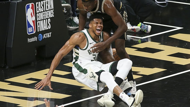 Jun 29, 2021; Atlanta, Georgia, USA; Milwaukee Bucks forward Giannis Antetokounmpo (34) and Atlanta Hawks center Clint Capela (15) fall to the floor as Antetokounmpo (34) is injured on the play in the third quarter during game four of the Eastern Conference Finals for the 2021 NBA Playoffs at State Farm Arena. Mandatory Credit: Brett Davis-USA TODAY Sports