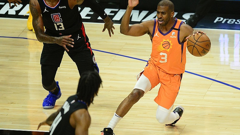 Jun 30, 2021; Los Angeles, California, USA; Phoenix Suns guard Chris Paul (3) controls the ball against Los Angeles Clippers guard Paul George (13) during the first half in game six of the Western Conference Finals for the 2021 NBA Playoffs at Staples Center. Mandatory Credit: Gary A. Vasquez-USA TODAY Sports