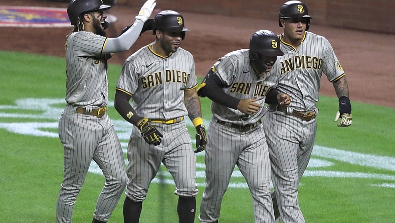 Jun 30, 2021; Cincinnati, Ohio, USA; San Diego Padres center fielder Trent Grisham (second from right) celebrates with shortstop Fernando Tatis Jr. (left) left fielder Tommy Pham (28) and third baseman Manny Machado (right) after hitting a grand slam against the Cincinnati Reds during the fifth inning at Great American Ball Park. Mandatory Credit: David Kohl-USA TODAY Sports