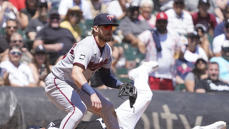 Jul 1, 2021; Chicago, Illinois, USA; Chicago White Sox third baseman Yoan Moncada (10) is safe at third base as Minnesota Twins third baseman Josh Donaldson (20) takes a late throw during the third inning at Guaranteed Rate Field. Mandatory Credit: David Banks-USA TODAY Sports