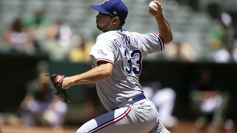 Jul 1, 2021; Oakland, California, USA; Texas Rangers starting pitcher Dane Dunning (33) delivers a pitch against the Oakland Athletics in the second inning at RingCentral Coliseum. Mandatory Credit: D. Ross Cameron-USA TODAY Sports