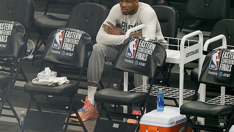 Jul 1, 2021; Milwaukee, Wisconsin, USA; Milwaukee Bucks forward Giannis Antetokounmpo sits on the sidelines during warmups before game five of the Eastern Conference Finals against the Atlanta Hawks during the 2021 NBA Playoffs at Fiserv Forum. Mandatory Credit: Jeff Hanisch-USA TODAY Sports