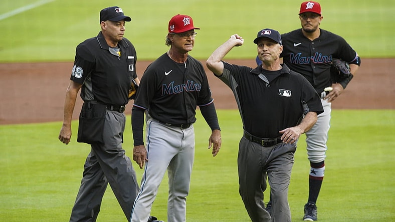 Jul 2, 2021; Atlanta, Georgia, USA; umpire Dan Iassogna (58) throws Miami Marlins manager Don Mattingly (8) out of a game against the Atlanta Braves in the first inning at Truist Park. Mandatory Credit: Brett Davis-USA TODAY Sports