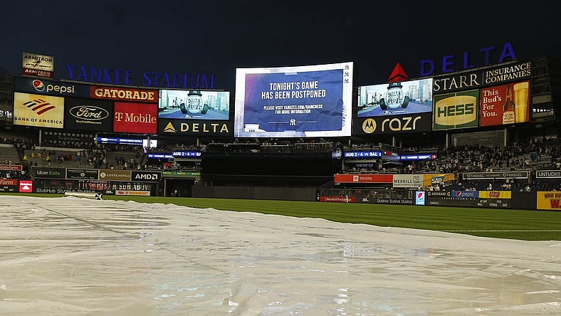 Jul 2, 2021; Bronx, New York, USA; A general view of Yankee Stadium with the tarp on the field and the video board announcing the game between the New York Mets and the New York Yankees has been postponed at Yankee Stadium. Mandatory Credit: Andy Marlin-USA TODAY Sports