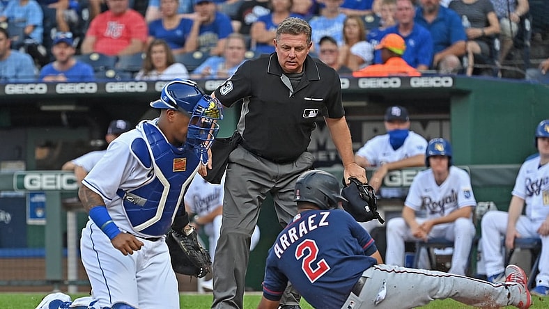 Jul 2, 2021; Kansas City, Missouri, USA;  Minnesota Twins second baseman Luis Arraez (2) slides home to score a run against Kansas City Royals catcher Salvador Perez (13) during the first inning at Kauffman Stadium. Mandatory Credit: Peter Aiken-USA TODAY Sports