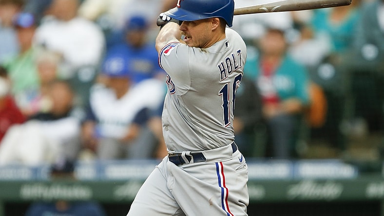 Jul 2, 2021; Seattle, Washington, USA; Texas Rangers third baseman Brock Holt (16) hits a two run single against the Seattle Mariners during the third inning at T-Mobile Park. Mandatory Credit: Joe Nicholson-USA TODAY Sports