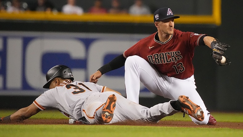 Jul 2, 2021; Phoenix, Arizona, USA; San Francisco Giants center fielder LaMonte Wade Jr (31) dives into secondbase under the tag of Arizona Diamondbacks shortstop Nick Ahmed (13) after hitting a double in the third inning at Chase Field. Mandatory Credit: Rick Scuteri-USA TODAY Sports