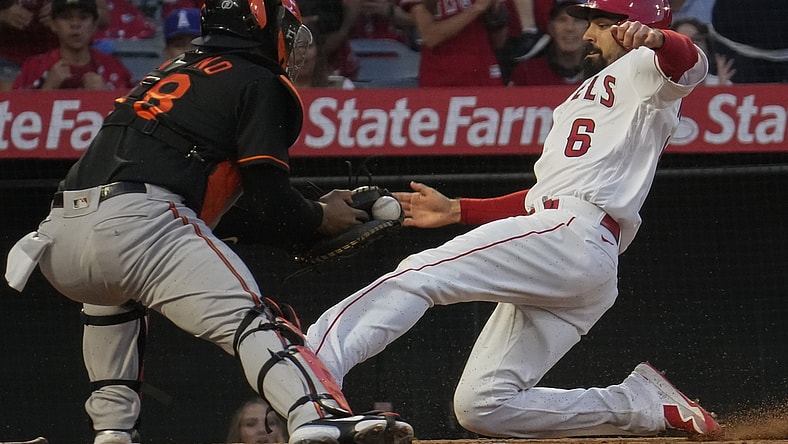 Jul 2, 2021; Anaheim, California, USA; Los Angeles Angels third baseman Anthony Rendon (6) slides into home as Baltimore Orioles catcher Pedro Severino waits with the ball during the third inning at Angel Stadium.Rendon was safe on the play.  Mandatory Credit: Robert Hanashiro-USA TODAY Sports