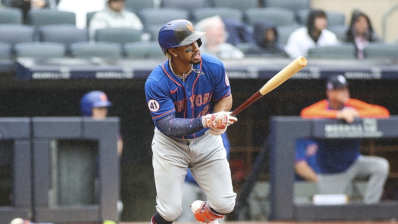 Jul 3, 2021; Bronx, New York, USA;  New York Mets shortstop Francisco Lindor (12) hits a single in the fifth inning against the New York Yankees at Yankee Stadium. Mandatory Credit: Wendell Cruz-USA TODAY Sports