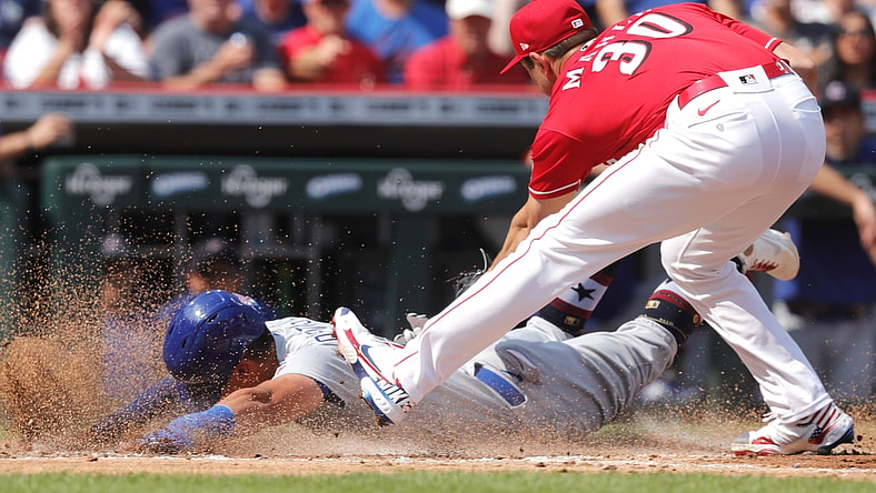 Jul 3, 2021; Cincinnati, Ohio, USA; Chicago Cubs center fielder Rafael Ortega (66) is safe at home after a wild pitch from Cincinnati Reds starting pitcher Tyler Mahle (30)  during the second inning at Great American Ball Park. Mandatory Credit: David Kohl-USA TODAY Sports