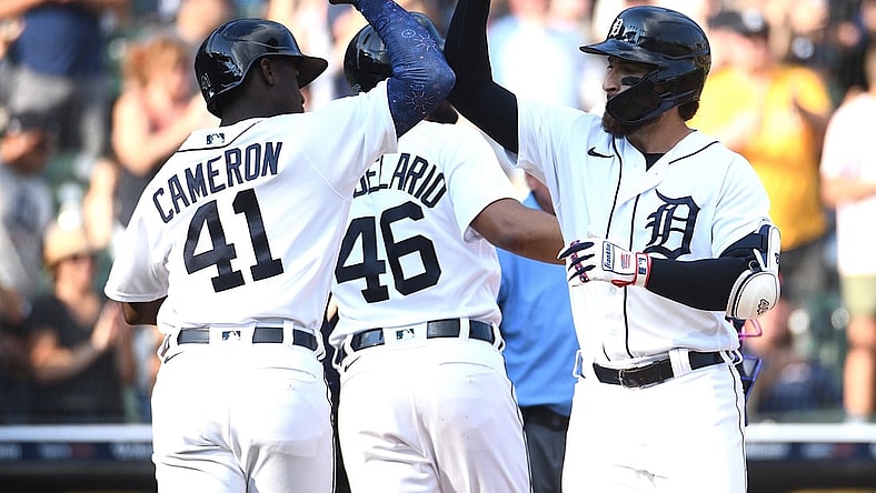Jul 3, 2021; Detroit, Michigan, USA; Detroit Tigers left fielder Eric Haase (13) celebrates his home run with Chicago White Sox bench coach Miguel Cairo (41) during the game at Comerica Park. Mandatory Credit: Tim Fuller-USA TODAY Sports