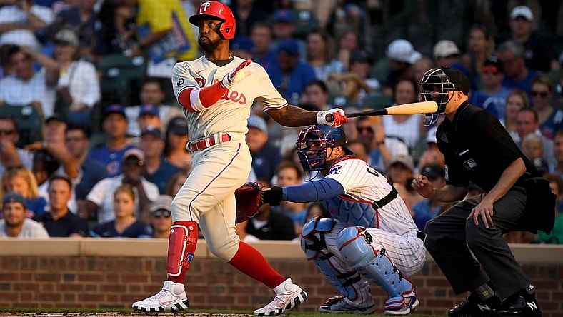 Jul 5, 2021; Chicago, Illinois, USA; Philadelphia Phillies center fielder Andrew McCutchen (22) hits a double in the second inning against the Chicago Cubs at Wrigley Field. Mandatory Credit: Quinn Harris-USA TODAY Sports