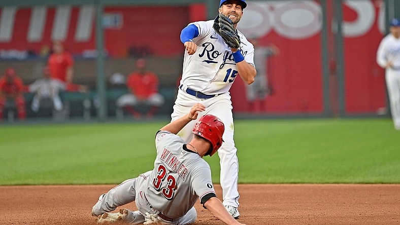 Jul 5, 2021; Kansas City, Missouri, USA;  Kansas City Royals second baseman Whit Merrifield (15) completes a double play with a throw to first over Cincinnati Reds designated hitter Jesse Winker (33) during the fourth inning at Kauffman Stadium. Mandatory Credit: Peter Aiken-USA TODAY Sports