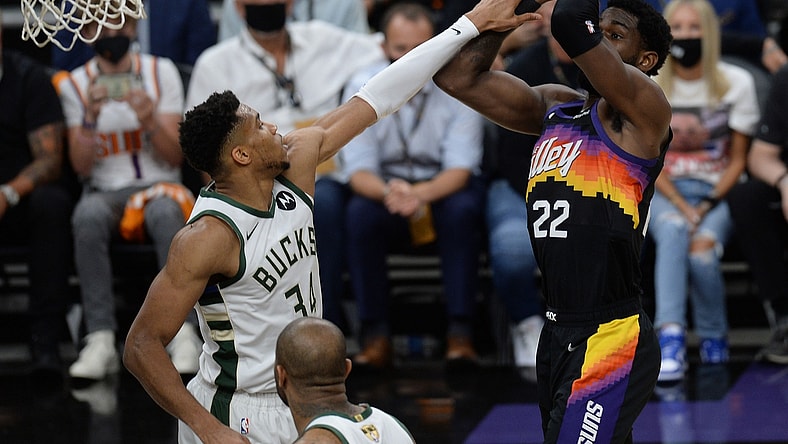 Jul 6, 2021; Phoenix, Arizona, USA; Phoenix Suns center Deandre Ayton (22) shoots against Milwaukee Bucks forward Giannis Antetokounmpo (34) during the first half in game one of the 2021 NBA Finals at Phoenix Suns Arena. Mandatory Credit: Joe Camporeale-USA TODAY Sports