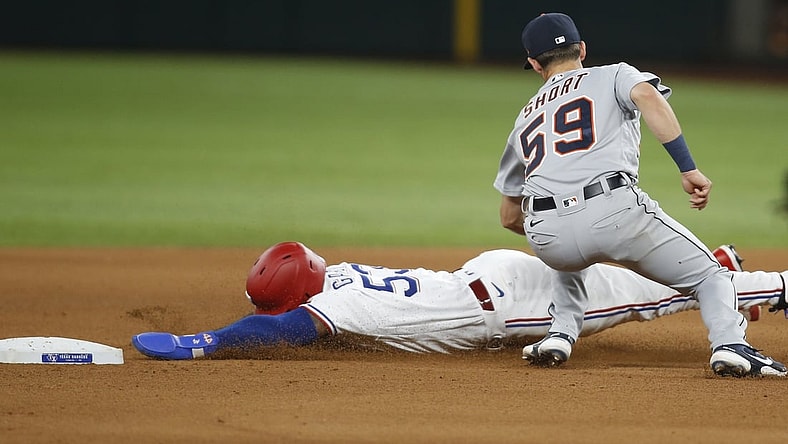 Jul 6, 2021; Arlington, Texas, USA; Detroit Tigers shortstop Zack Short (59) tags out Texas Rangers center fielder Adolis Garcia (53) as he attempts to steal second base in the fourth inning at Globe Life Field. Mandatory Credit: Tim Heitman-USA TODAY Sports