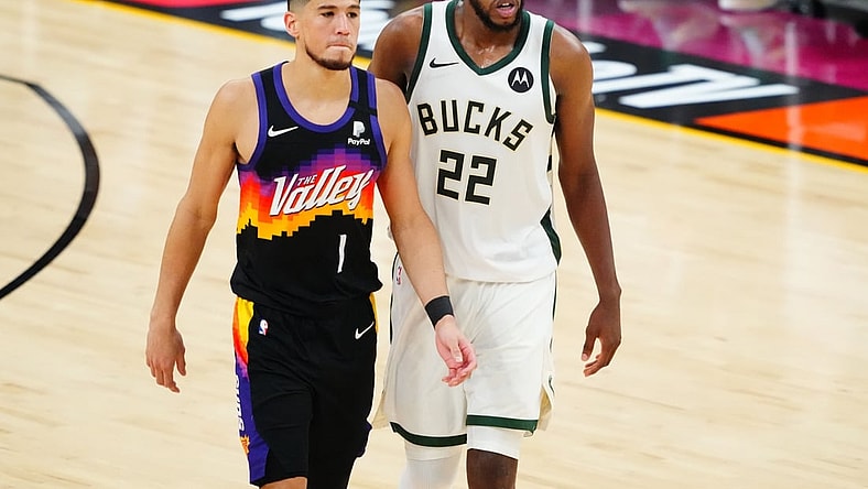 Jul 6, 2021; Phoenix, Arizona, USA; Phoenix Suns guard Devin Booker (1) alongside Milwaukee Bucks forward Khris Middleton (22) during the second half in game one of the 2021NBA Finals at Phoenix Suns Arena. Mandatory Credit: Mark J. Rebilas-USA TODAY Sports