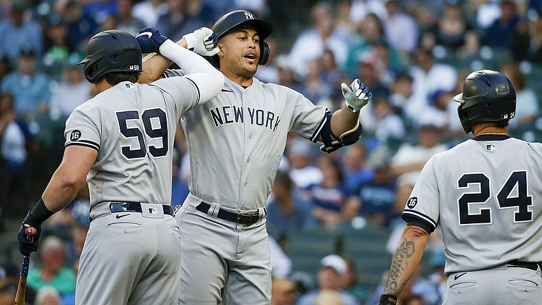 Jul 6, 2021; Seattle, Washington, USA; New York Yankees designated hitter Giancarlo Stanton (27) bumps forearms with first baseman Luke Voit (59) following a three-run home run against the Seattle Mariners during the first inning at T-Mobile Park. Mandatory Credit: Joe Nicholson-USA TODAY Sports