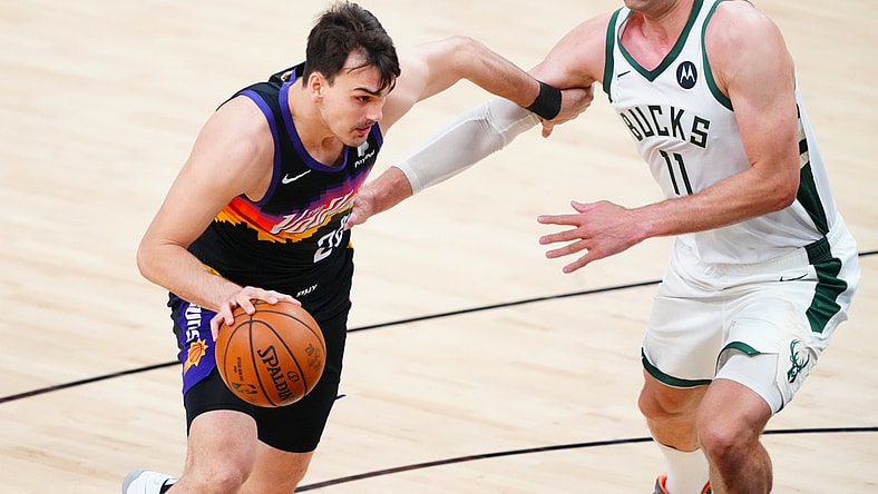 Jul 6, 2021; Phoenix, Arizona, USA; Phoenix Suns forward Dario Saric (20) drives to the basket against Milwaukee Bucks center Brook Lopez (11) during game one of the 2021 NBA Finals at Phoenix Suns Arena. Mandatory Credit: Mark J. Rebilas-USA TODAY Sports