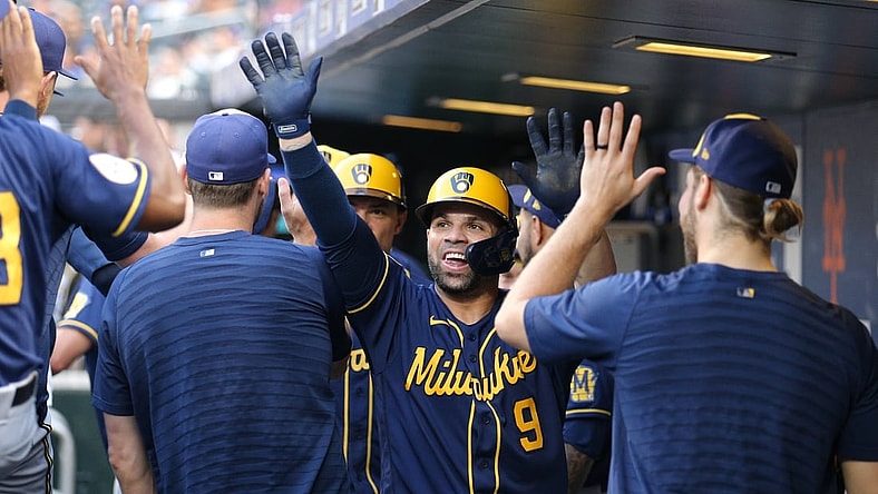 Jul 7, 2021; New York City, New York, USA; Milwaukee Brewers catcher Manny Pina (9) celebrates in the dugout with teammates after hitting a two run home run against the New York Mets during the second inning at Citi Field. Mandatory Credit: Brad Penner-USA TODAY Sports