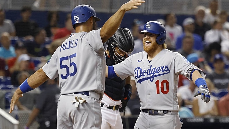 Jul 7, 2021; Miami, Florida, USA; Los Angeles Dodgers third baseman Justin Turner (10) is greeted at the plate by first baseman Albert Pujols (55) after hitting a three run home run during the third inning against the Miami Marlins at loanDepot Park. Mandatory Credit: Rhona Wise-USA TODAY Sports