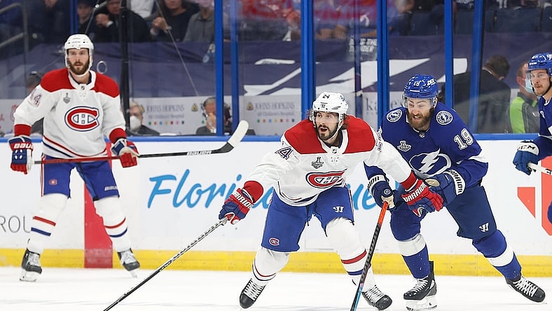 Jul 7, 2021; Tampa, Florida, USA; Montreal Canadiens left wing Phillip Danault (24) reaches for the puck against the Tampa Bay Lightning during the first period in game five of the 2021 Stanley Cup Final at Amalie Arena. Mandatory Credit: Kim Klement-USA TODAY Sports