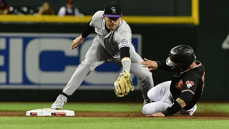 Jul 7, 2021; Phoenix, Arizona, USA;  Arizona Diamondbacks first baseman Christian Walker (53) is tagged out by Colorado Rockies shortstop Trevor Story (27) in the second inning at Chase Field. Mandatory Credit: Matt Kartozian-USA TODAY Sports