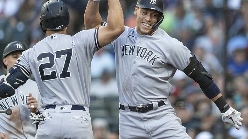 Jul 7, 2021; Seattle, Washington, USA; New York Yankees right fielder Aaron Judge (99) is congratulated by designated hitter Giancarlo Stanton (27) after hitting a two-run home run off of Seattle Mariners starting pitcher Yusei Kikuchi (not pictured) that also scored leftfielder Tim Locastro (not pictured) during the second inning at T-Mobile Park. Mandatory Credit: Stephen Brashear-USA TODAY Sports