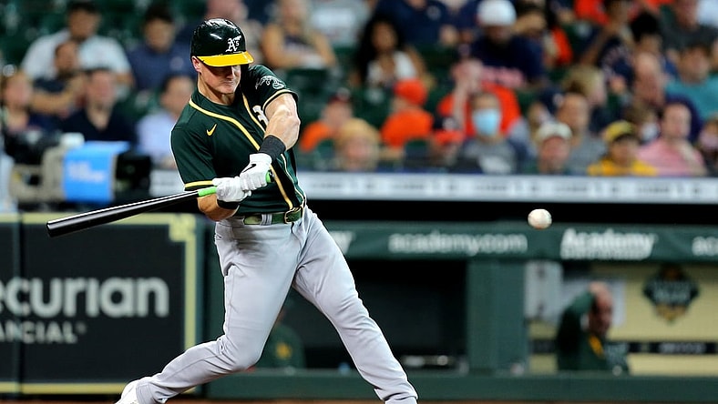 Jul 8, 2021; Houston, Texas, USA; Oakland Athletics third baseman Matt Chapman (26) hits a single against the Houston Astros during the fifth inning at Minute Maid Park. Mandatory Credit: Erik Williams-USA TODAY Sports