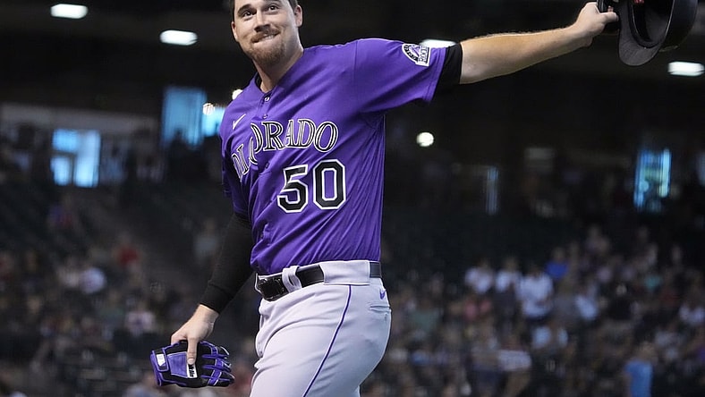 Jul 8, 2021; Phoenix, Arizona, USA; Colorado Rockies starting pitcher Chi Chi Gonzalez (50) reacts after hitting an RBI single against the Arizona Diamondbacks in the fourth inning at Chase Field. Mandatory Credit: Rick Scuteri-USA TODAY Sports