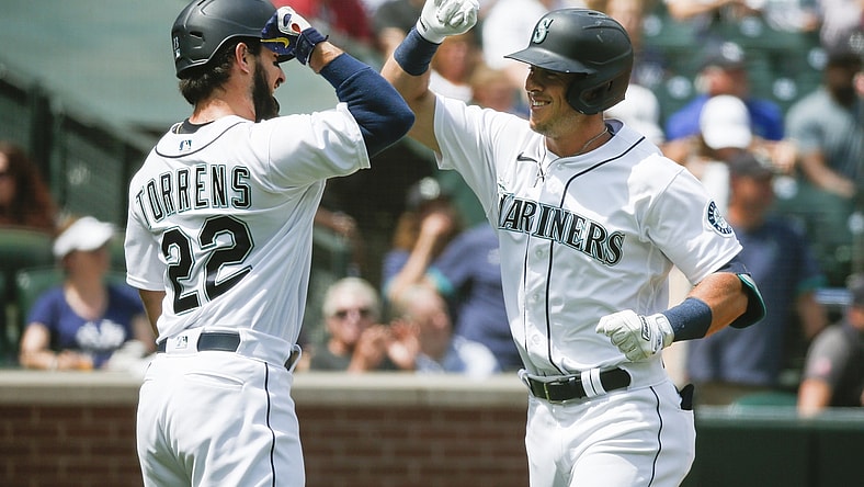 Jul 8, 2021; Seattle, Washington, USA; Seattle Mariners second baseman Dylan Moore (right) celebrates with designated hitter Luis Torrens (22) after hitting a two-run home run against the New York Yankees during the second inning at T-Mobile Park. Mandatory Credit: Joe Nicholson-USA TODAY Sports