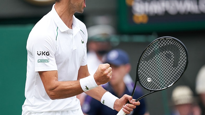Jul 9, 2021; London, United Kingdom; Novak Djokovic (SRB) celebrates winning his men   s semi final against Denis Shapovalov (CAN) at All England Lawn Tennis and Croquet Club. Mandatory Credit: Peter van den Berg-USA TODAY Sports