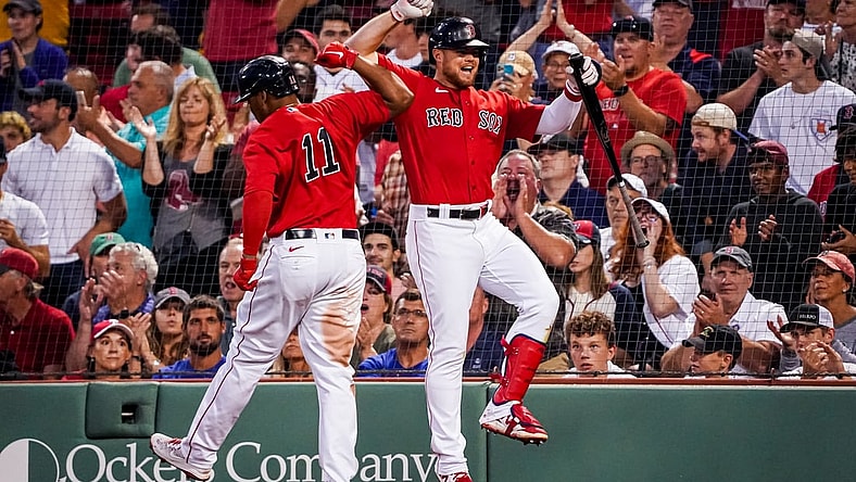 Jul 9, 2021; Boston, Massachusetts, USA; Boston Red Sox third baseman Rafael Devers (11) is congratulated after hitting a home run against the Philadelphia Phillies in the third inning at Fenway Park. Mandatory Credit: David Butler II-USA TODAY Sports