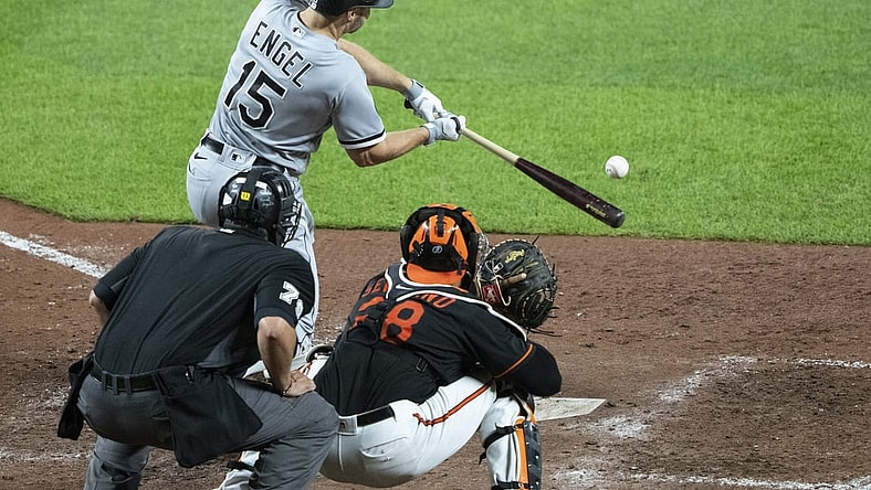 Jul 9, 2021; Baltimore, Maryland, USA; Chicago White Sox center fielder Adam Engel (15) hits a sacrifice fly during the sixth inning against the Baltimore Orioles at Oriole Park at Camden Yards. Mandatory Credit: Gregory Fisher-USA TODAY Sports
