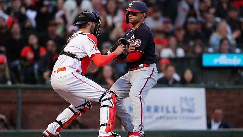 Jul 9, 2021; San Francisco, California, USA; Washington Nationals center fielder Gerardo Parra gets tagged out at home plate by San Francisco Giants catcher Curt Casali (2) during the fourth inning at Oracle Park. Mandatory Credit: Sergio Estrada-USA TODAY Sports