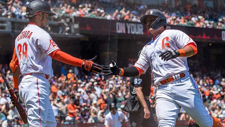 Jul 10, 2021; San Francisco, California, USA;  San Francisco Giants second baseman Donovan Solano (7) celebrates with left fielder Thairo Estrada (39) after scoring a run against the Washington Nationals in the third inning at Oracle Park. Mandatory Credit: John Hefti-USA TODAY Sports