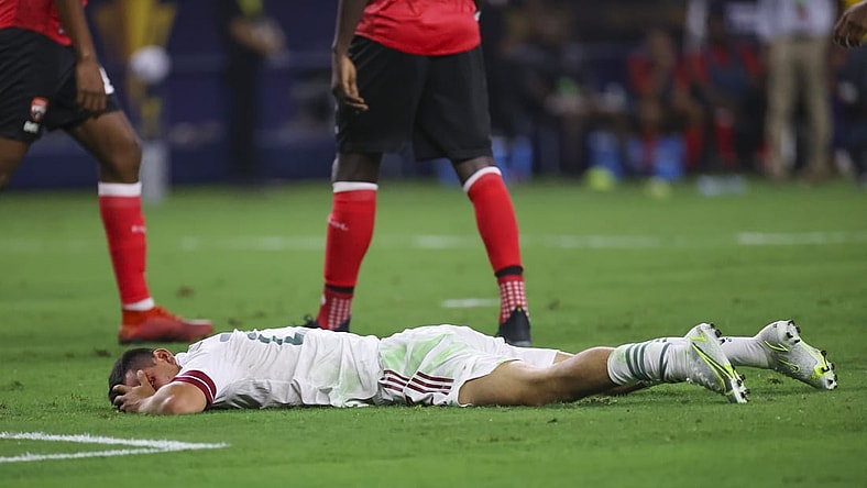 Jul 10, 2021; Arlington, Texas, USA; Mexico forward Hirving Lozano (22) lays injured during the first half of a CONCACAF Gold Cup group stage soccer match against the Trinidad and Tobago at AT&T Stadium. Mandatory Credit: Kevin Jairaj-USA TODAY Sports