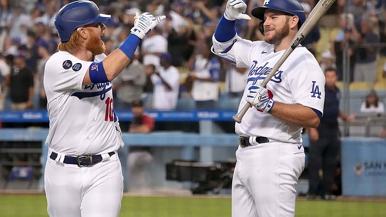 Jul 10, 2021; Los Angeles, California, USA; Los Angeles Dodgers third baseman Justin Turner (10) celebrates with second baseman Max Muncy (right) after hitting a grand slam home run against the Arizona Diamondbacks in the second inning at Dodger Stadium. Mandatory Credit: Kirby Lee-USA TODAY Sports